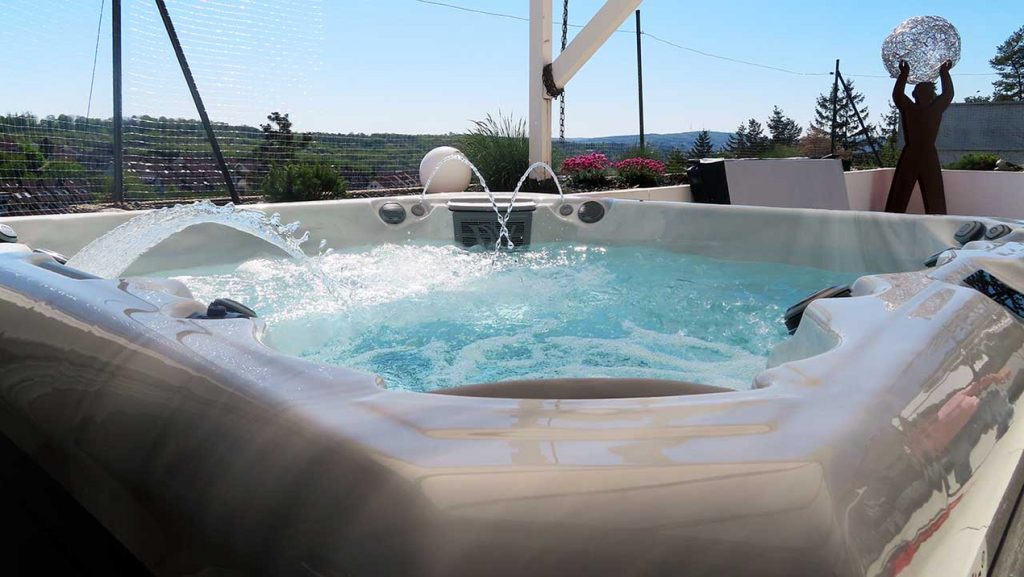Nahaufnahme eines sprudelnden Whirlpools. Der Himmel im Hintergrund ist klar und wolkenlos